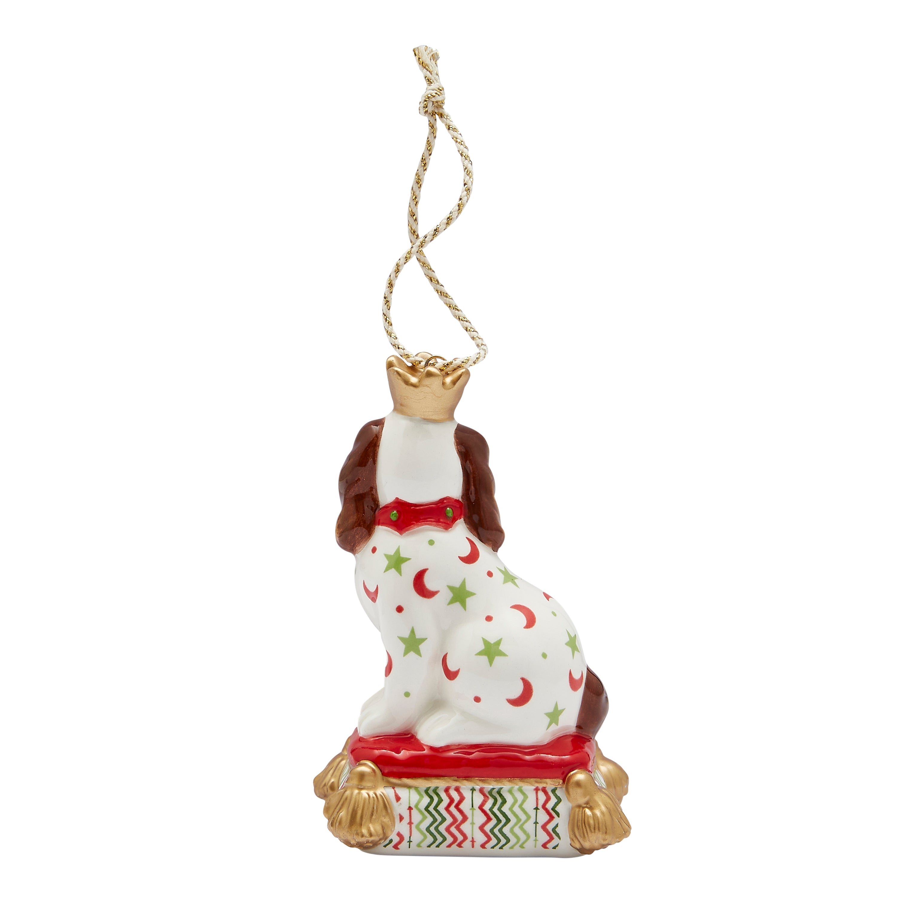Festive fine china Christmas tree decoration in the shape of a sitting Staffordshire Dog. Inspired by Kit's patchwork animals, this stylish ornament features bright patterns (red crescent moons, green stars) and gold accents, and sits on a grand red and pattern cushion.