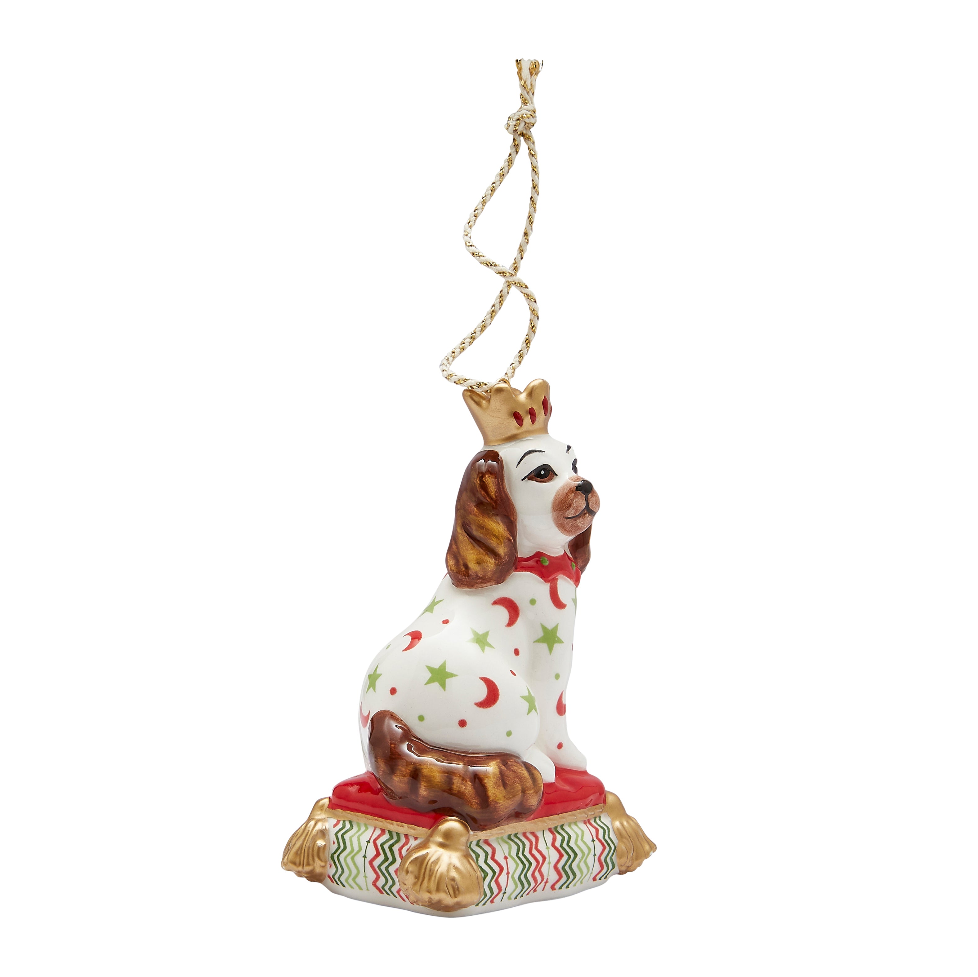 Festive fine china Christmas tree decoration in the shape of a sitting Staffordshire Dog. Inspired by Kit's patchwork animals, this stylish ornament features bright patterns (red crescent moons, green stars) and gold accents, making it a unique and delightful addition to any Christmas tree or a perfect gift for a dog lover.