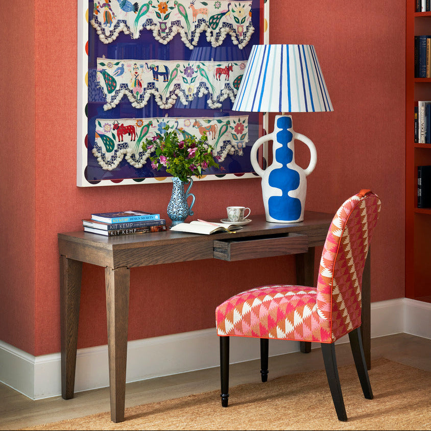Susan Chair in Busy Lizzie fabric, combined with Kit Kemp oak desk, Tall Trees tea cup and saucer, and Kit Kemp design books.