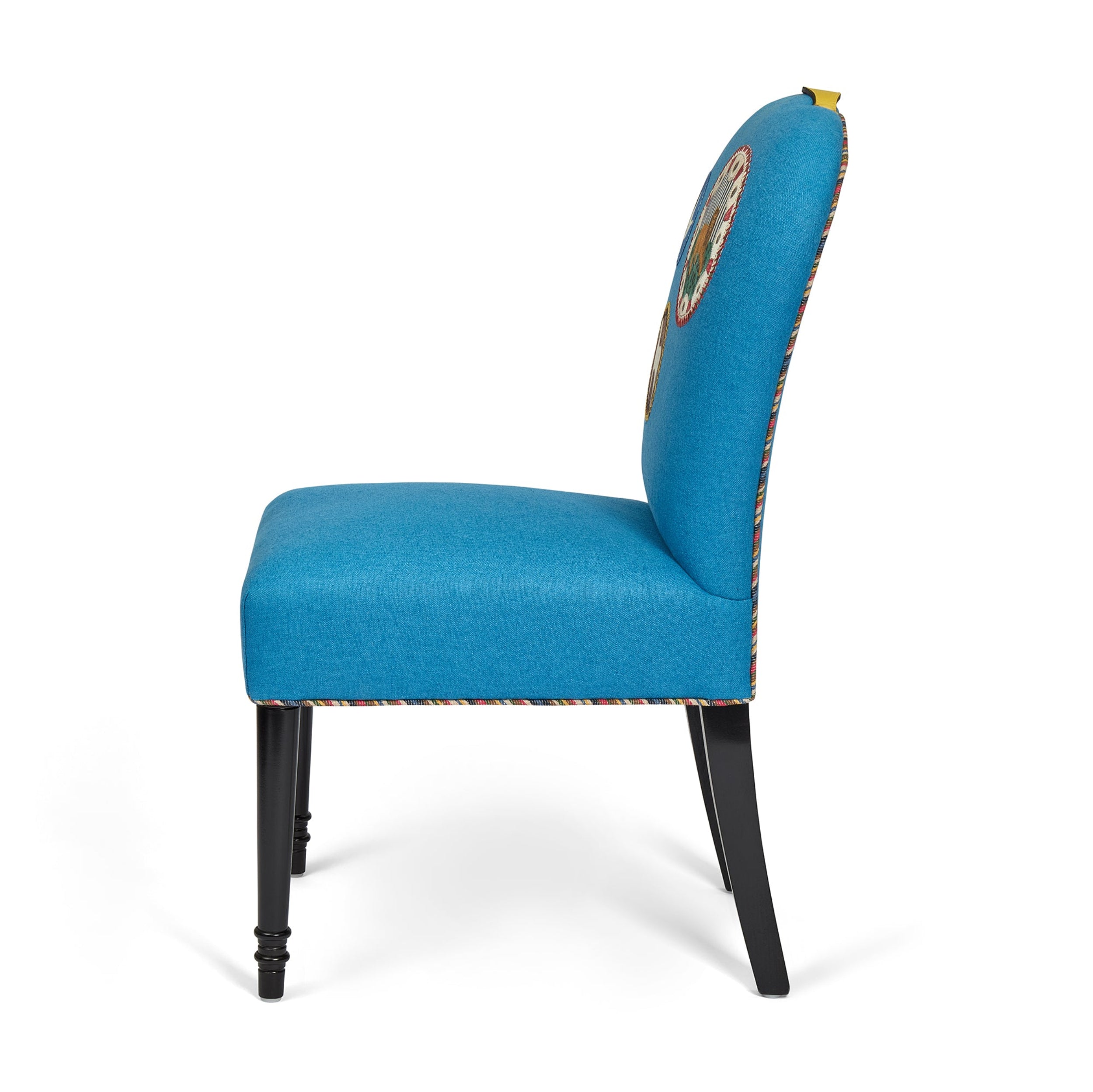 Blue upholstered chair with a decorative backrest on a white background