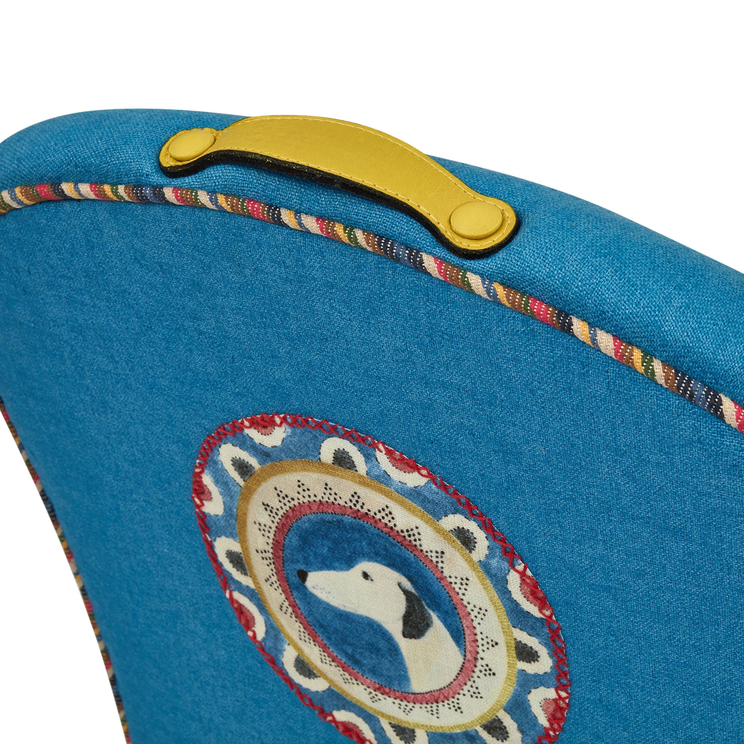 Blue bag with a colorful handle and embroidered dog design on a white background