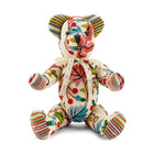 A limited-edition Sycamore Willow Bear meticulously crafted from Pierre Frey Fronsac fabric. The bear features a sophisticated woollen chain stitch embroidery on a cream linen base, showcasing a colourful and naïve pattern of intertwined foliage and floral bouquets.