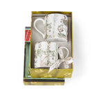 A set of fine bone china mugs, hand-painted in 24-carat gold, presented in a gift box with a ribbon.