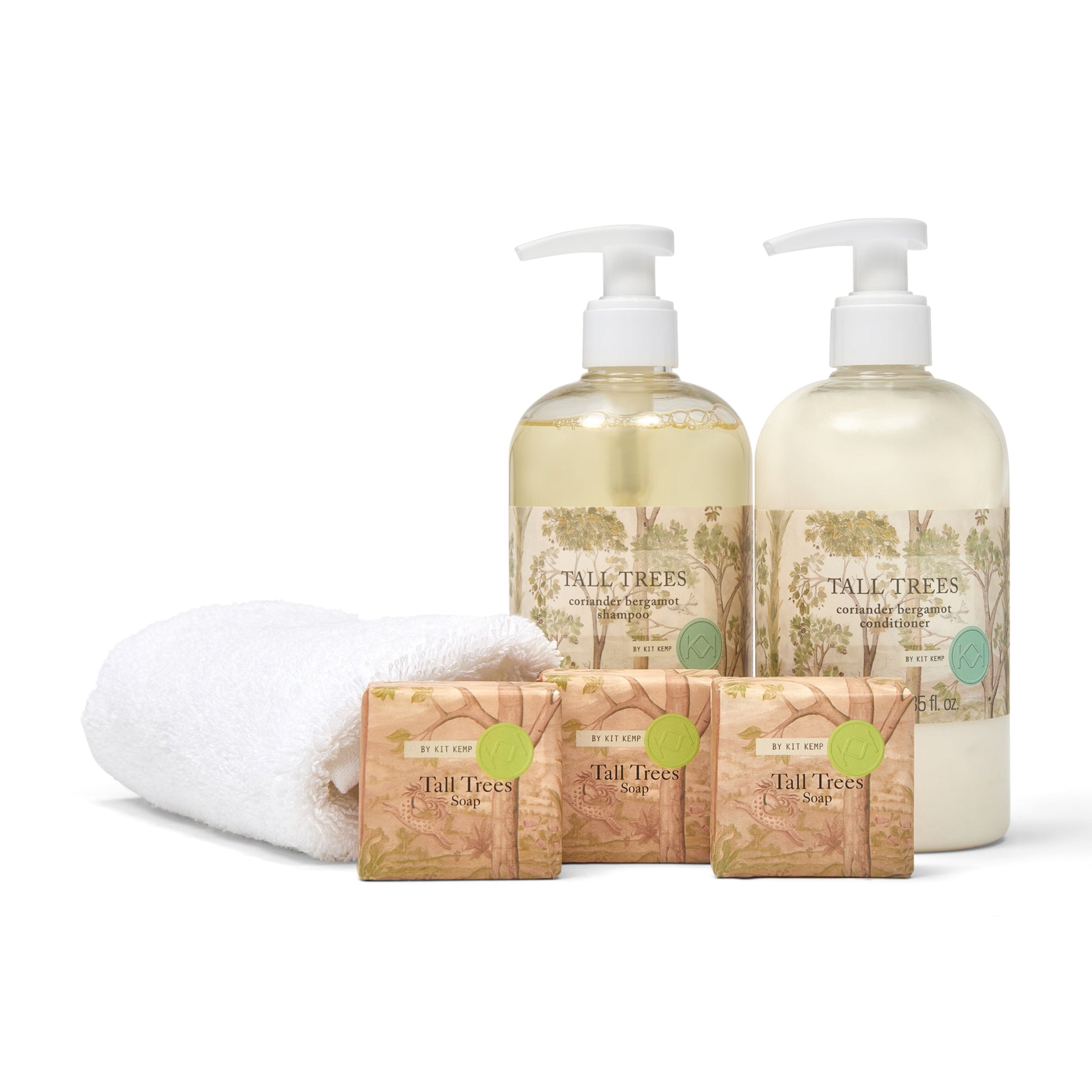 Tall Trees bath and body products including bottles, soap bars, and a towel on a white background