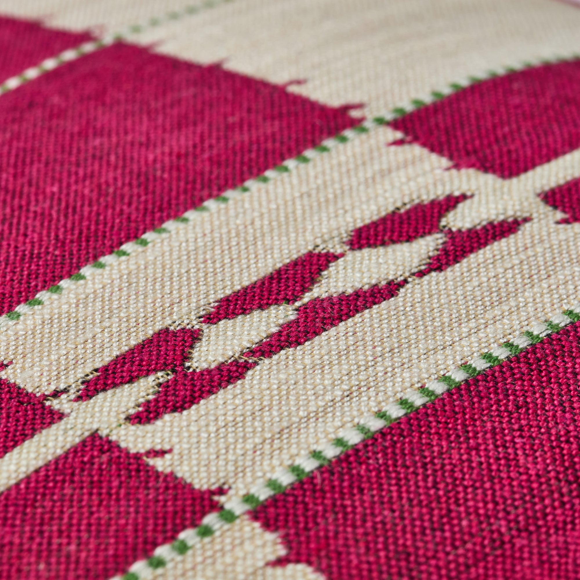 Kit Kemp Design Studio cushion featuring a bold floral and chequerboard design in raspberry, pink, and beige. Made from upcycled signature fabrics "Tasha’s Trip" and "Chubby Check," this sustainable accessory brings a playful 70s vibe to any table or sofa. A vibrant, rhythmic pattern statement that is as practical as it is stylish.
