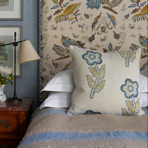 Tasha's Trip Peace & Love Cushion at Firmdale Reston Place interior by Kit Kemp, in hues of blues and golds, with embroidery details.