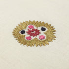 Hand-embroidered Kit Kemp Design Studio cushion featuring intricate Suzani motifs in a palette of pink and mauve on a linen-cotton base. This 41cm (16in) square cushion showcases the collaboration with Chelsea Textiles, complete with a contrasting pink piped edge and unique pattern placement.