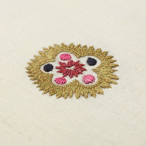 Hand-embroidered Kit Kemp Design Studio cushion featuring intricate Suzani motifs in a palette of pink and mauve on a linen-cotton base. This 41cm (16in) square cushion showcases the collaboration with Chelsea Textiles, complete with a contrasting pink piped edge and unique pattern placement.