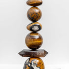 Ancient Sands II is entirely unique and made from the following precious crystal stones: From the top – 2 pieces of Yellow Jasper, Tigers Eye, Pietersite sphere, Yellow Jasper, Tigers Eye sphere, Smokey Quartz rod and a large form of Yellow Jasper.  All sitting on an Iroko wood plinth. Size H43cm W11.5cm D11.5cm includes base.
