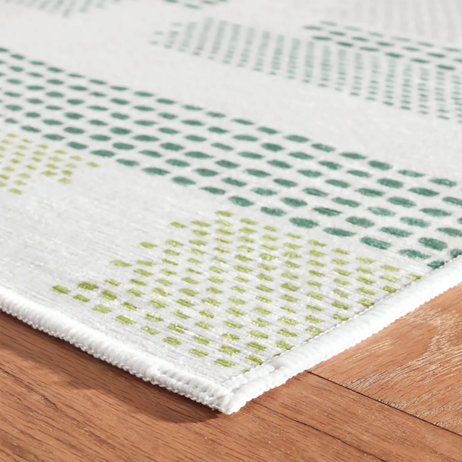 Detail of Tread Lightly Green washable rug, perfect for high traffic indoor areas, and to add Kit Kemp design details to kitchen and bathroom areas.