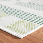 Detail of Tread Lightly Green washable rug, perfect for high traffic indoor areas, and to add Kit Kemp design details to kitchen and bathroom areas.