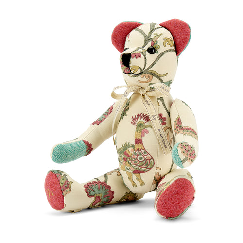 Special edition Tree of Life Willow Bear, featuring a sophisticated blend of 100% linen and colourful wool accents. This artisanal character includes intricate cockerel embroidery, vibrant pink ears and footpads, turquoise knit paws, and a numbered "3/4" stamp on the foot to denote its limited-edition, handmade status.