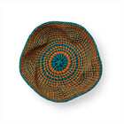 Woven basket with green and orange, and organic shape that softens the striped pattern.