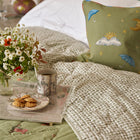 Acrylic tray on bed with bed quilt, tall trees mug and plate. 