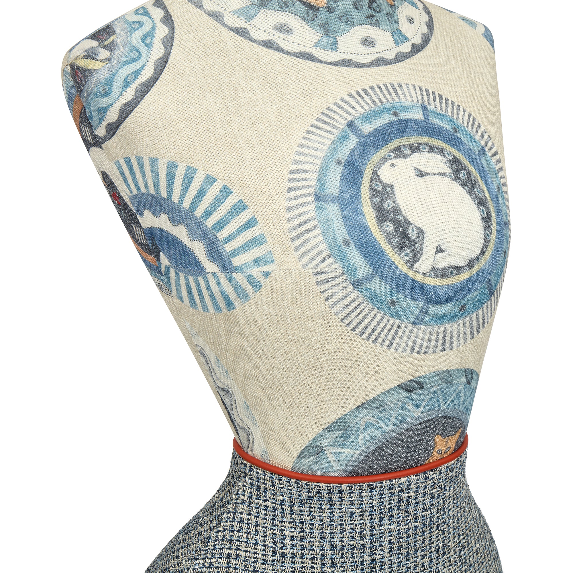 Mannequin wearing a patterned dress with blue and white designs on a beige background