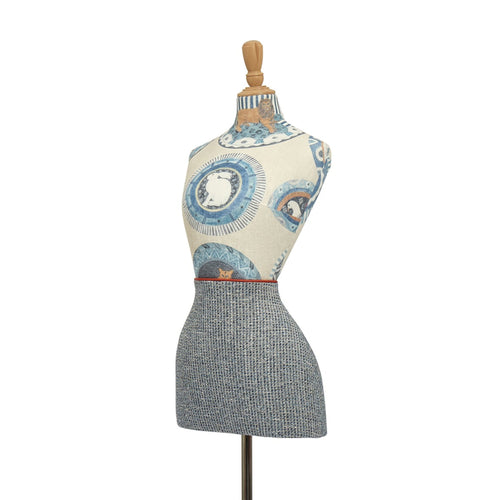 Mannequin torso with floral top and checkered skirt on a white background