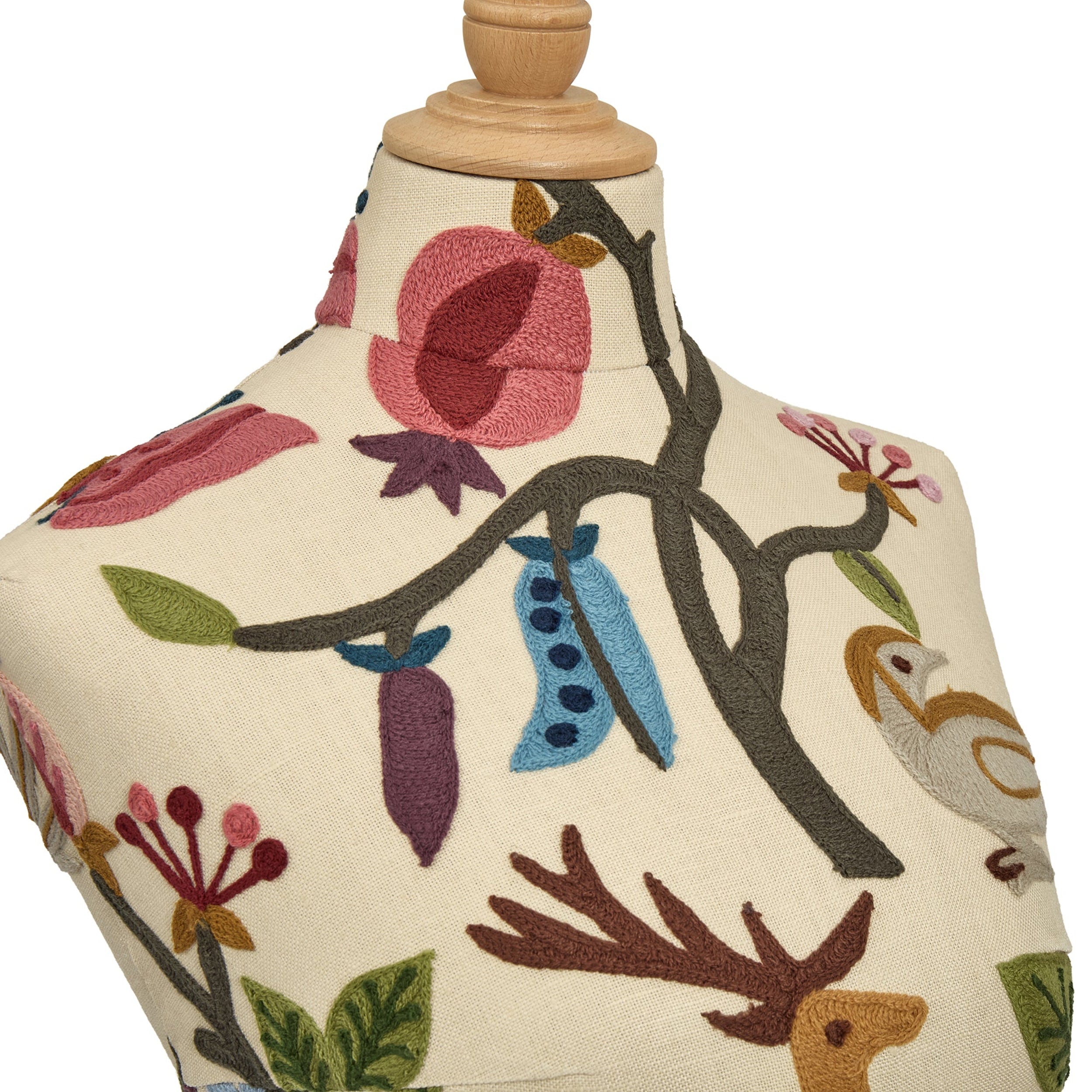 Mannequin torso with embroidered floral and nature-themed design on a white background