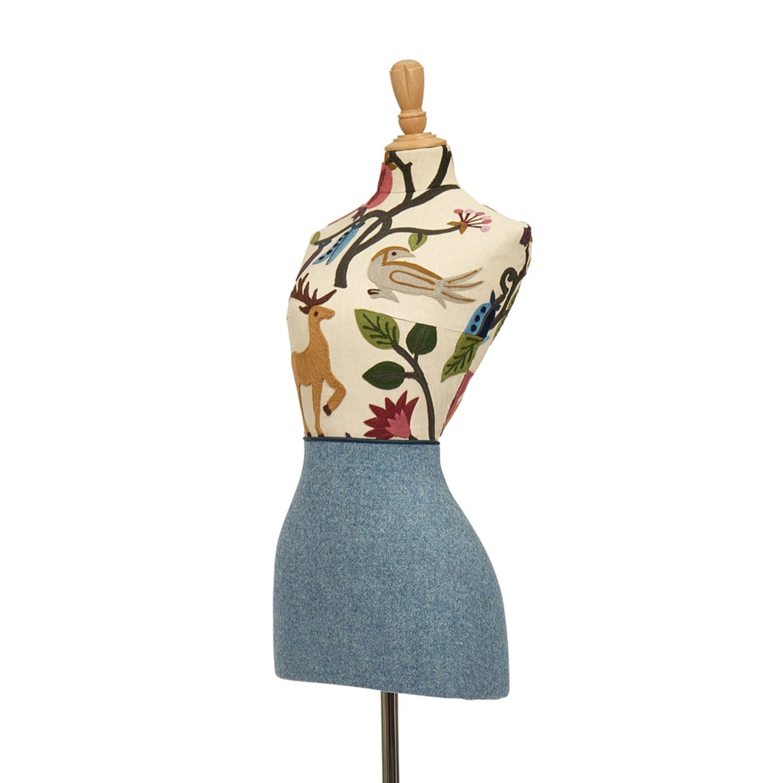 Mannequin torso with floral patterned top and denim skirt on a white background