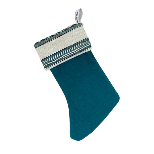 An elegant Christmas stocking featuring the distinct blue Woven Ribbon design in a tactile, woven texture. Ethically produced from fabric offcuts as part of a commitment to sustainable, zero-waste design.