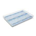 A rectangular Kit Kemp clear acrylic tray featuring an artisan fabric inlay of the "Wriggle Room" pattern. The design showcases playful, painterly blue geometric chevrons and stripes on a white background with subtle yellow accents. The tray is engineered for a premium weight and thickness, offering a sleek, stackable solution for styling ottomans or dining tables.