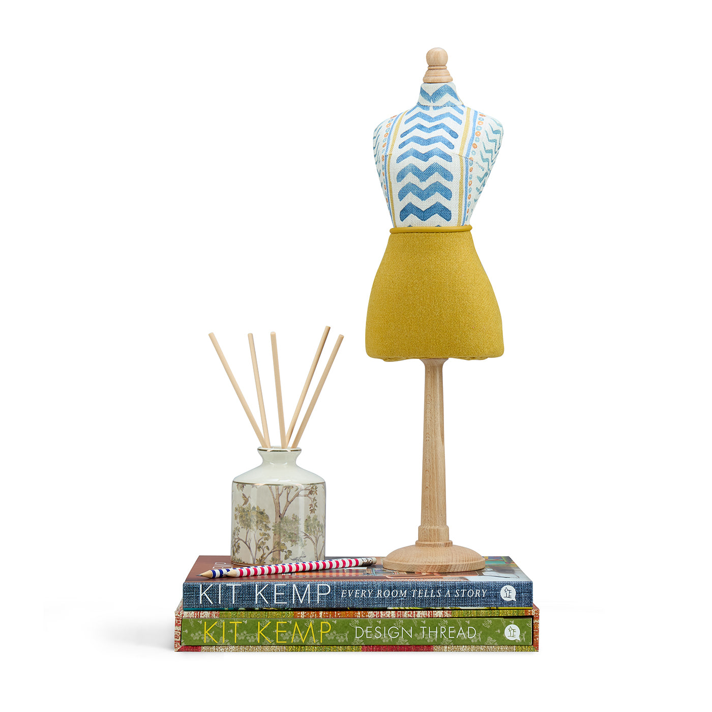 A decorative handmade mini mannequin by Kit Kemp. The paper-mâché torso is upholstered in a blue chevron "Wriggle Room" fabric, paired with a textured yellow linen skirt. 