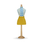 A handmade Kit Kemp mini mannequin that injects immediate personality into any space. The torso features the distinctive "Wriggle Room" fabric, a playful blue and white chevron that brings a sense of movement and rhythm. This is perfectly balanced by a vibrant, sun-drenched yellow linen skirt, creating a high-contrast colour story that turns a simple shelf or desk into a curated design statement.