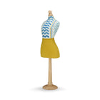 This versatile decorative piece celebrates the tactile beauty of handmade art. The rich texture of the yellow linen skirt provides a grounded, organic feel that beautifully complements the crisp, graphic blue patterns of the upholstered paper-mâché torso. By mixing the boldness of the primary yellow with the intricate "Wriggle Room" print, this mannequin adds a layer of sophisticated vibrancy and "artisan-made" charm to a room's decor.