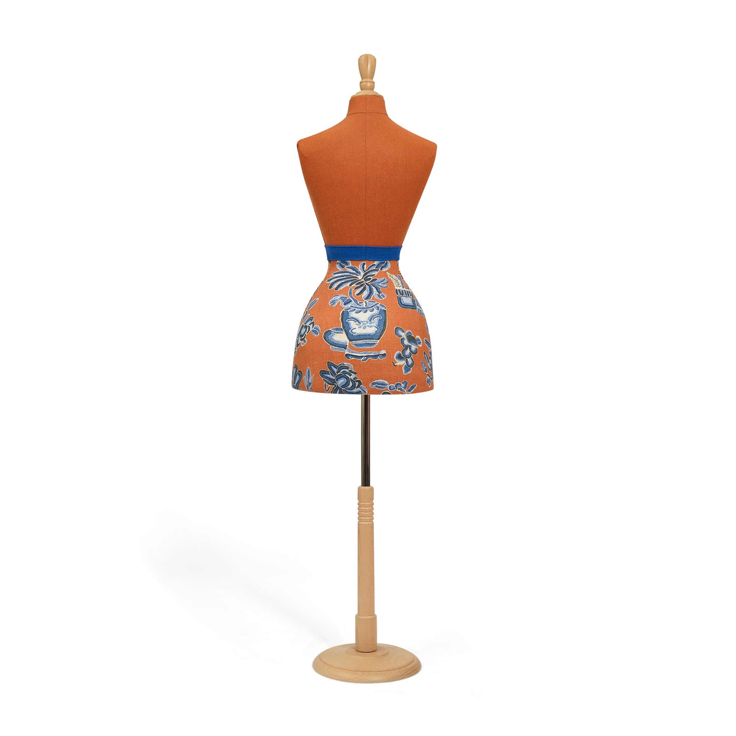 Orange apron with blue floral pattern on a mannequin against a white background