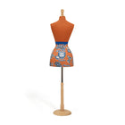 Orange apron with blue floral pattern on a mannequin against a white background