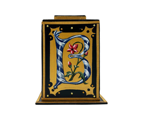 This black and gold alphabet box is decorated with a navy letter B in a heraldic decorative style, and embellished a red, blue and pearl jewelled lid. 