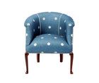 A tub chair upholstered in Kit Kemp's over the moon fabric in the denim colourway