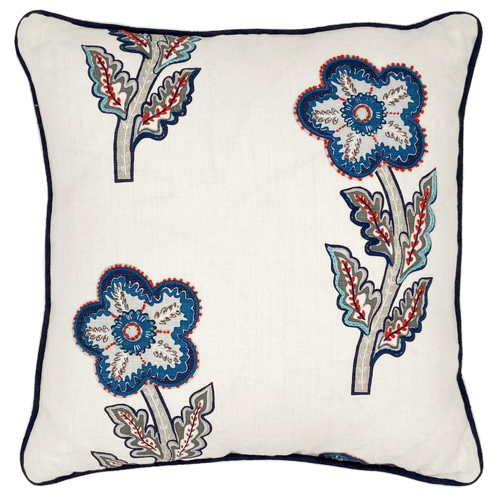 This a large 50x50 cushion with its white linen base cloth is printed with a large daisy like floral design in rich navy, pale blue and reds, and embellished with hand embroidered details, like chainstitch, and French knots, in red to add texture, with navy piping.