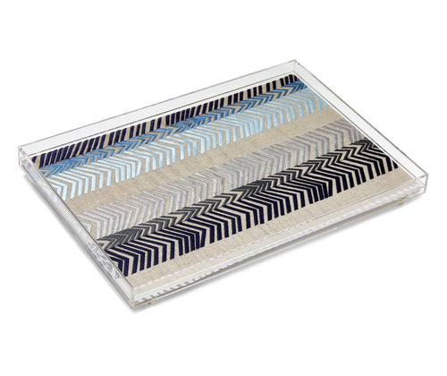 The Bookend Tray, show cases this cloth's embroidered chevron stripes in shades of blue and silver on a grey linen base cloth and adds a dash of color and pattern to this everyday object