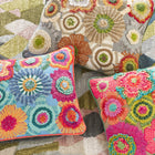 Group shot of all the colourways available in the Bramble hand embroidered Cushion, with Annie Selke. This wonderful cushion is bursting with hand embroidered florals, embellished with ribbons and boucle yarn to produce a cushions that is overflowing with design detail and colour, is available in in bright pinks, blues and oranges, and a natural option.