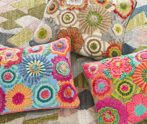 Group shot of all the colourways available in the Bramble hand embroidered Cushion, with Annie Selke. This wonderful cushion is bursting with hand embroidered florals, embellished with ribbons and boucle yarn to produce a cushions that is overflowing with design detail and colour, is available in in bright pinks, blues and oranges, and a natural option.