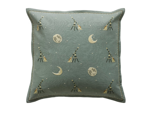 Kit Kemp for Chelsea Textiles. A square hand embroidered cushion featuring Kit Kemp's moondog design in blue linen. The design shows a whimsical dog wishing upon a star with the moon shining down upon him.