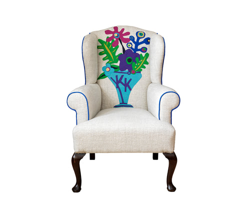 The completely bespoke Couture Wing chair with personalized initials woven into a Matisse inspired applique design. The chair features one of Kit's favorite fabrics, Pierre Freyís plain linen ëArseneí, as a fresh background against a selection of moon wools for the cut outs and piping. Front View