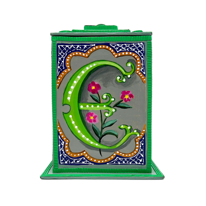 This bright green alphabet box is decorated with a green letter E in a heraldic decorative style, with a pink floral motif surrounded by blue trellis work and embellished with turquoise jewelled lid. 