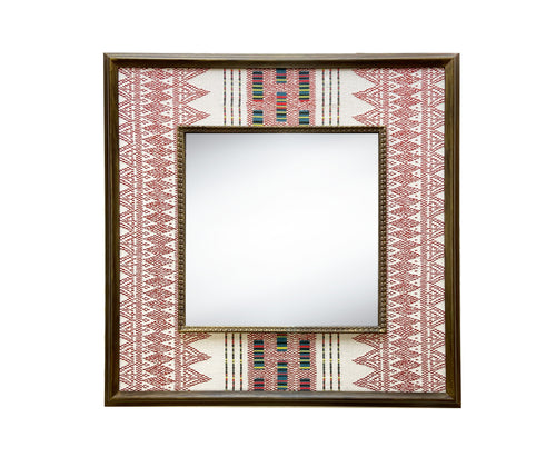 The Ethnic Embroidered Mirror, features in natural linen fabric, with broad stripes of earthy red stitchwork , with rectangular barcode-like panels in soft green, yellow and black contrasting to form an extra central design feature, stretched to form a wide decorative border around a square central mirror, in a wooden frame.