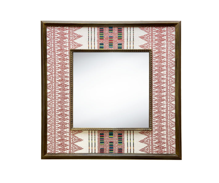 The Ethnic Embroidered Mirror, features in natural linen fabric, with broad stripes of earthy red stitchwork , with rectangular barcode-like panels in soft green, yellow and black contrasting to form an extra central design feature, stretched to form a wide decorative border around a square central mirror, in a wooden frame.