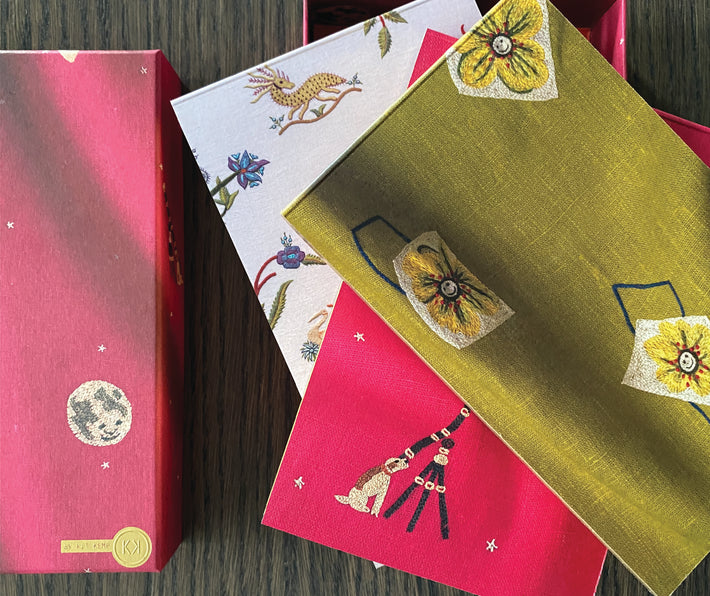 3 notebooks in three different Kit Kemp's designs for Chelsea Textiles: Friendly Flowers, Mythical Creatures and pink Moondog.