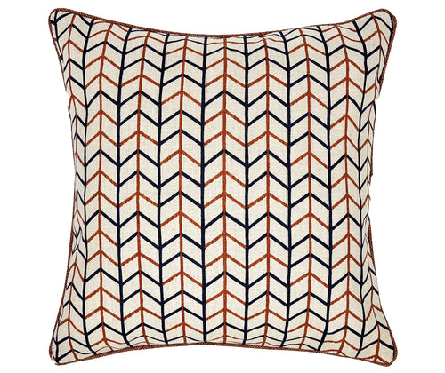 This image shows a decorative square cushion with a geometric pattern. The design features a series of interlocking lines in blue and terracotta orange, The background of the pillow appears to be off-white. The edges of the pillow are neatly finished with a piping of a red parquet fabric