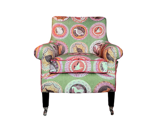 Kit's snug and useful Leo armchair, in the Robina's Dinner Party fabric, from the new collection with GP&J Baker, takes on a fun new look. Robina's Dinner Party fabric is a celebration of one of Kit's favourite ceramists: Robina Jack, with her decorative plates, with whimsical animals taking centre stage, against an apple green background, with contrasting orange piping. 