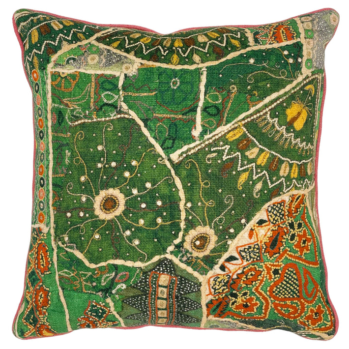 Our Front Row cushion in green, from Kit Kemp's new collection with GP & J Baker, is a patchwork print of intricately detailed decorative designs, in bright green jewel-like tones, with yellow, and terracotta highlights, and is piped with a contrasting coral piping. 