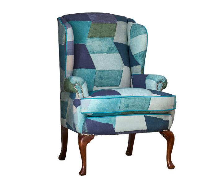 This new incarnation of Kit's Wing chair is a standout piece , upholstered in Kit's Zig Zag printed fabric from her new collection with Christopher Farr. Zig Zag's dynamic pattern intertwining abstract diamonds to give this fabric a vibrant rhythmic movement, in bold shades of turquoise and blue, its a free-moving and big statement piece.