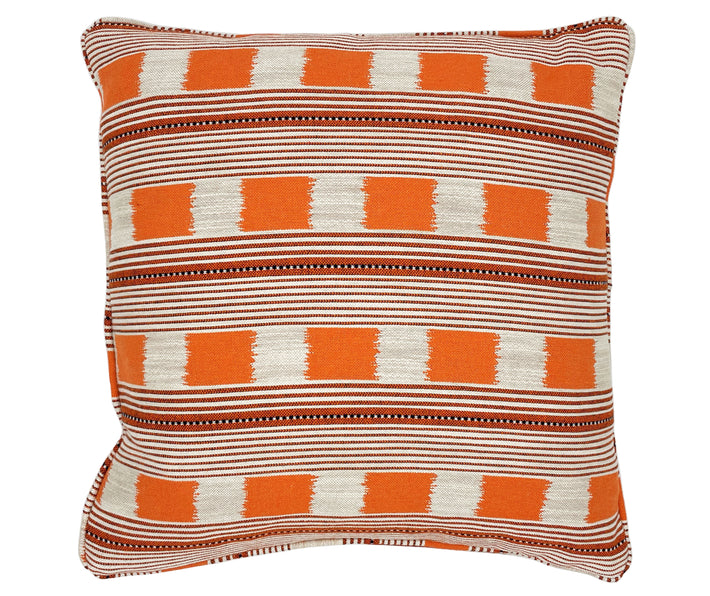 An orange & ecru cushion, in Kit's Lost and Found fabric, which is a design made up of chequer board squares, framed by panels of narrow ecru and orange stripes, and contrast navy tipping.