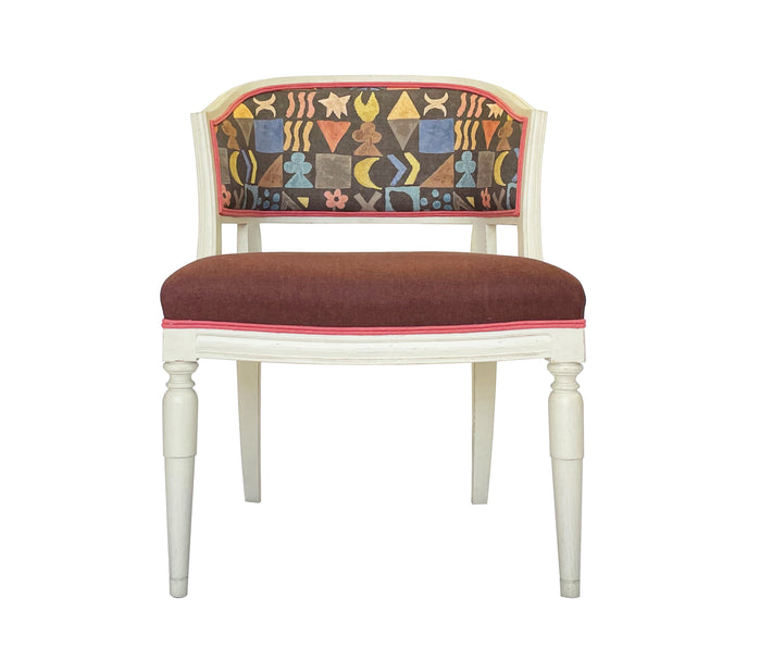 Kit Kemp's signature Whitby chair with its white wooden frame is the perfect vehicle to allow your creativity to run wild, with contrasting colours and patterns, this version in Potatoes' Print, part of Kit's new fabric collaboration with GP& J Baker, is a feast of colour, pattern and texture, with its patterned back, plain brown seat and contrasting red double piping. 