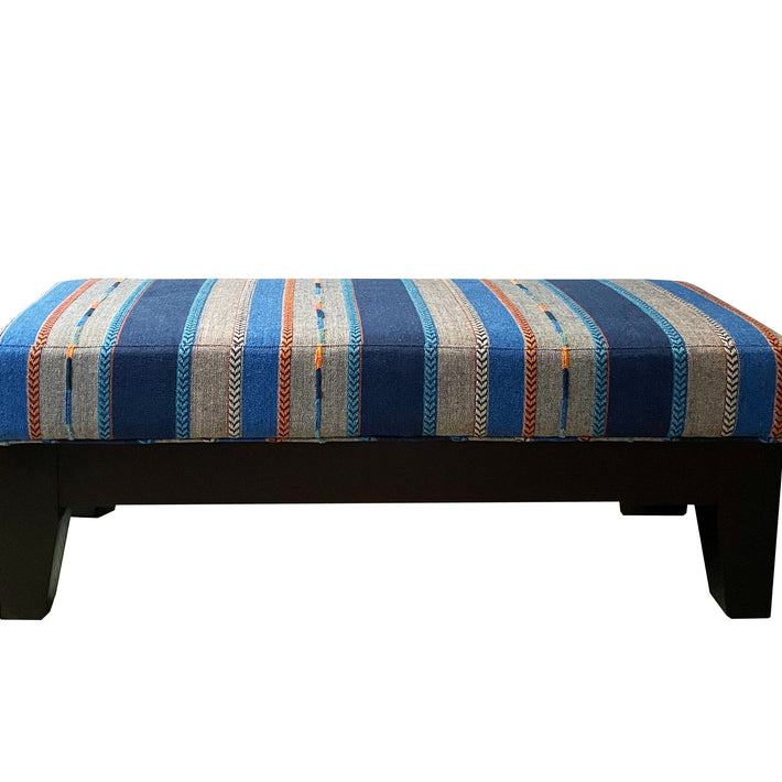 Kit Kemp's end of bed stool is given a refresh in this wonderful textured stripe, from Kit Kemp's new collection with GP&J Baker, with its wide stripes and embroidery detailing in shots of orange, this piece is a vibrant addition to your bedroom, or hall.