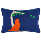 The image displays the front of the Labrador cushion, a decorative cushion with a vibrant design. The cushion's background is a bright blue, and it features a white stylized tree with green leaves. Next to the tree, there is a prominent silhouette of a Labrador dog in orange colour. The pillow's rectangular shape and colorful artwork give it a playful and modern aesthetic, intended to serve as a decorative element in a home