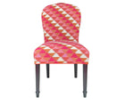 The Susan chair , with its upholstered curved back, and dark wenge wood legs is covered in the Busy Lizzy woven fabric, designed , made up of a zig zagged edged triangle in shades of pink, orange and cream, and piped in orange trim.